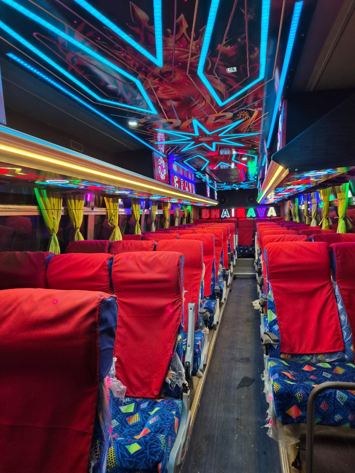 Bhairava luxury coach interior with vibrant ambient lighting and plush pushback seats